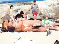 A lady enjoying the refreshing sea breeze in a natural, topless state. 4