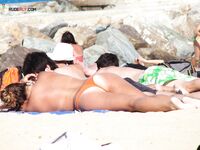 A lady enjoying the refreshing sea breeze in a natural, topless state. 4