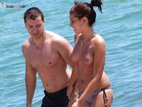 Two Adults Leaving the Water at a Topless Beach