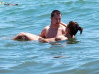 Two Adults Leaving the Water at a Topless Beach