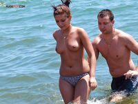 Two Adults Leaving the Water at a Topless Beach