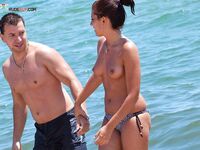 Two Adults Leaving the Water at a Topless Beach