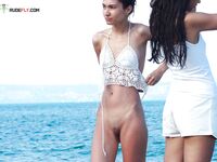 Two Women by the Sea in Crochet Top and White Shorts