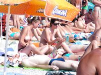 The liberation of a day at the beach with no tops and no worries.