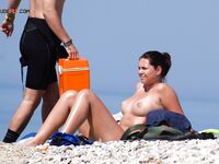 The artistic appeal of a bronzed body at a secluded and sun-drenched sandy retreat. 2