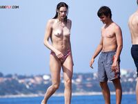 The artistic appeal of a bronzed body at a secluded and sun-drenched sandy retreat. 2