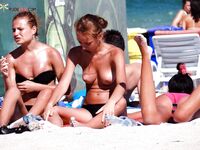 Lounger Relaxation in Blue Bikini Bottoms on a Busy Summer Beach