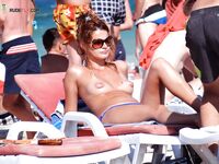 Lounger Relaxation in Blue Bikini Bottoms on a Busy Summer Beach