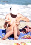 White Cap and Tan Lines Stepping From Nude Beach Surf