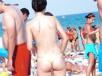Sunglasses and White Bikini Bottoms Beneath a Sun Umbrella