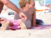 Capturing the graceful beauty of a woman at a nude coastal spot. 2