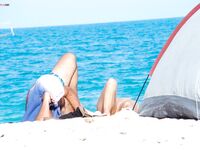 Bare Recline on Warm Sand Beside a Pitched Beach Tent