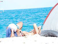 Bare Recline on Warm Sand Beside a Pitched Beach Tent