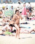 Embracing the European coastal tradition of topless summer relaxation. 3
