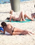 White Bikini Bottoms and a Colorful Umbrella on a Sandy Dune