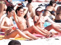 White Bikini Bottoms and a Colorful Umbrella on a Sandy Dune