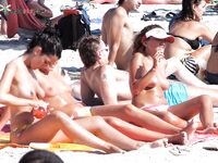 White Bikini Bottoms and a Colorful Umbrella on a Sandy Dune
