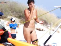 A lady finding her inner zen while sunbathing nude on a deserted shore. 4