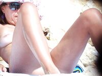 Pink Bikini Bottoms and a Floral Umbrella on a Busy Topless Beach