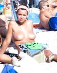 Sitting Upright Topless on a Crowded Beach Towel