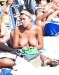 Sitting Upright Topless on a Crowded Beach Towel