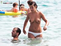 Sitting Upright Topless on a Crowded Beach Towel