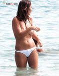 Sitting Upright Topless on a Crowded Beach Towel
