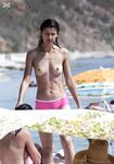 Capturing the essence of a carefree, topless summer at a natural coastline.