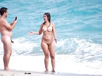 Two Nudists Posing for Photos at the Shoreline