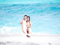 Two Nudists Posing for Photos at the Shoreline
