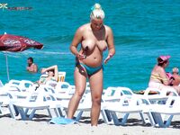 Such a cutie is a rare thing on a naturist strand. She was well protected by her companion.