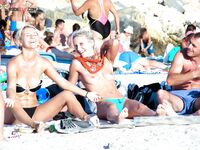 Such a cutie is a rare thing on a naturist strand. She was well protected by her companion.