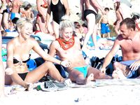 Such a cutie is a rare thing on a naturist strand. She was well protected by her companion.