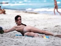 The aesthetic of a sun-kissed woman at a quiet, topless coastal location. 4