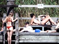 Three Nudists in a Grassy Clearing by the Foliage