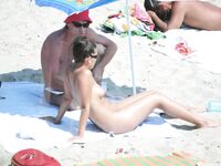 Nude Beach Stroll with Wet Hair and Silver Pendant