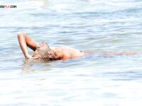 The soft light of the golden hour enhancing the natural glow of a bare body.