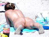 Capturing the authentic, relaxed atmosphere of a beach with topless visitors. 4