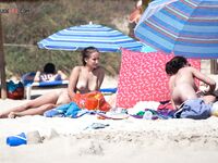 Finding a quiet place among the dunes to enjoy the sun in a classic naturist way.