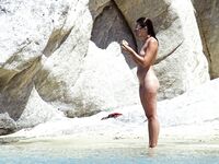 Wading Through Shallow Water at a Nude Beach
