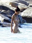 Wading Through Shallow Water at a Nude Beach
