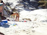 Wading Through Shallow Water at a Nude Beach