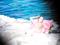 Wading Through Shallow Water at a Nude Beach