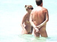Wading Through Shallow Water at a Nude Beach