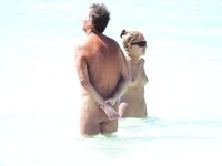 Wading Through Shallow Water at a Nude Beach