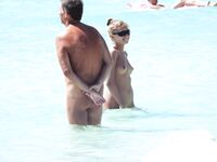 Wading Through Shallow Water at a Nude Beach