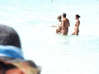 Wading Through Shallow Water at a Nude Beach