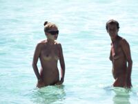 Wading Through Shallow Water at a Nude Beach