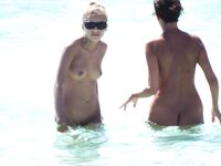 Wading Through Shallow Water at a Nude Beach