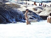 Wading Through Shallow Water at a Nude Beach